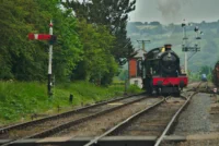 Classic Steam Locomotive on Green Tracks